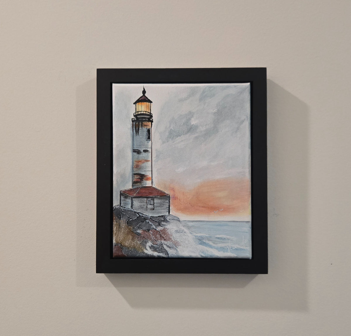 Rocky Shore Beacon original acrylic painting displayed in its black frame on a wall