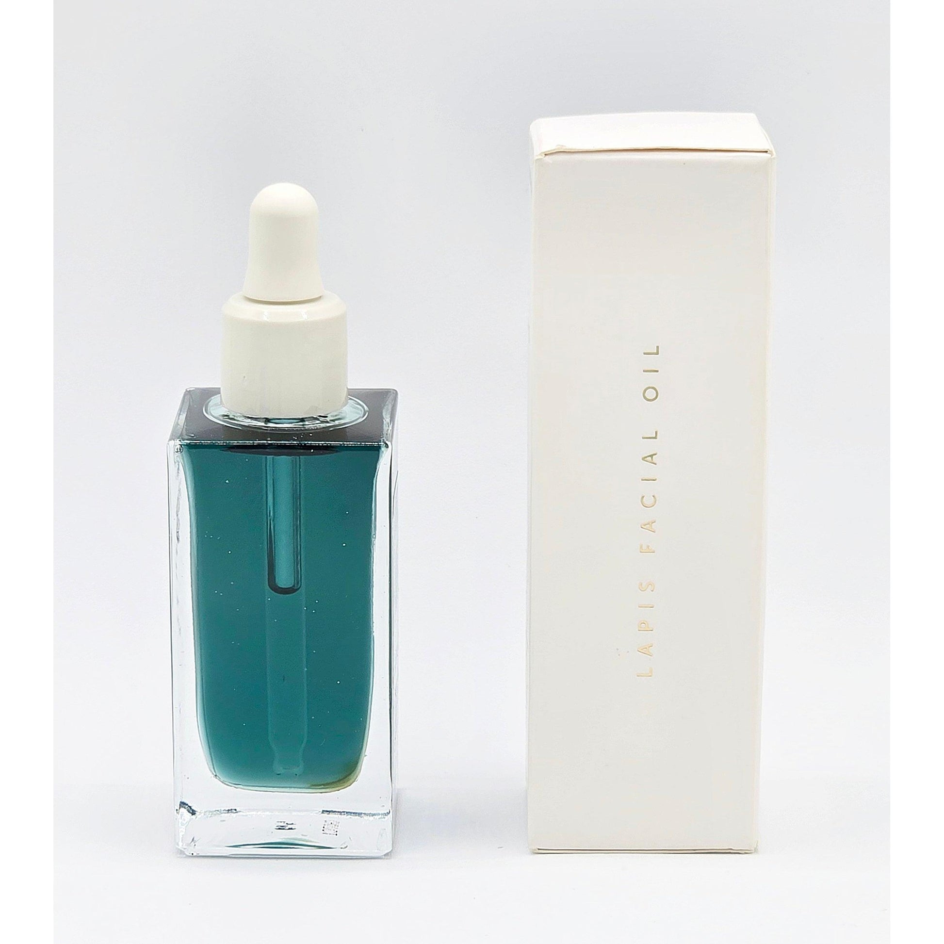 Herbivore Lapis Facial Oil in a rectangular clear glass bottle with a white dropper, next to its white box.