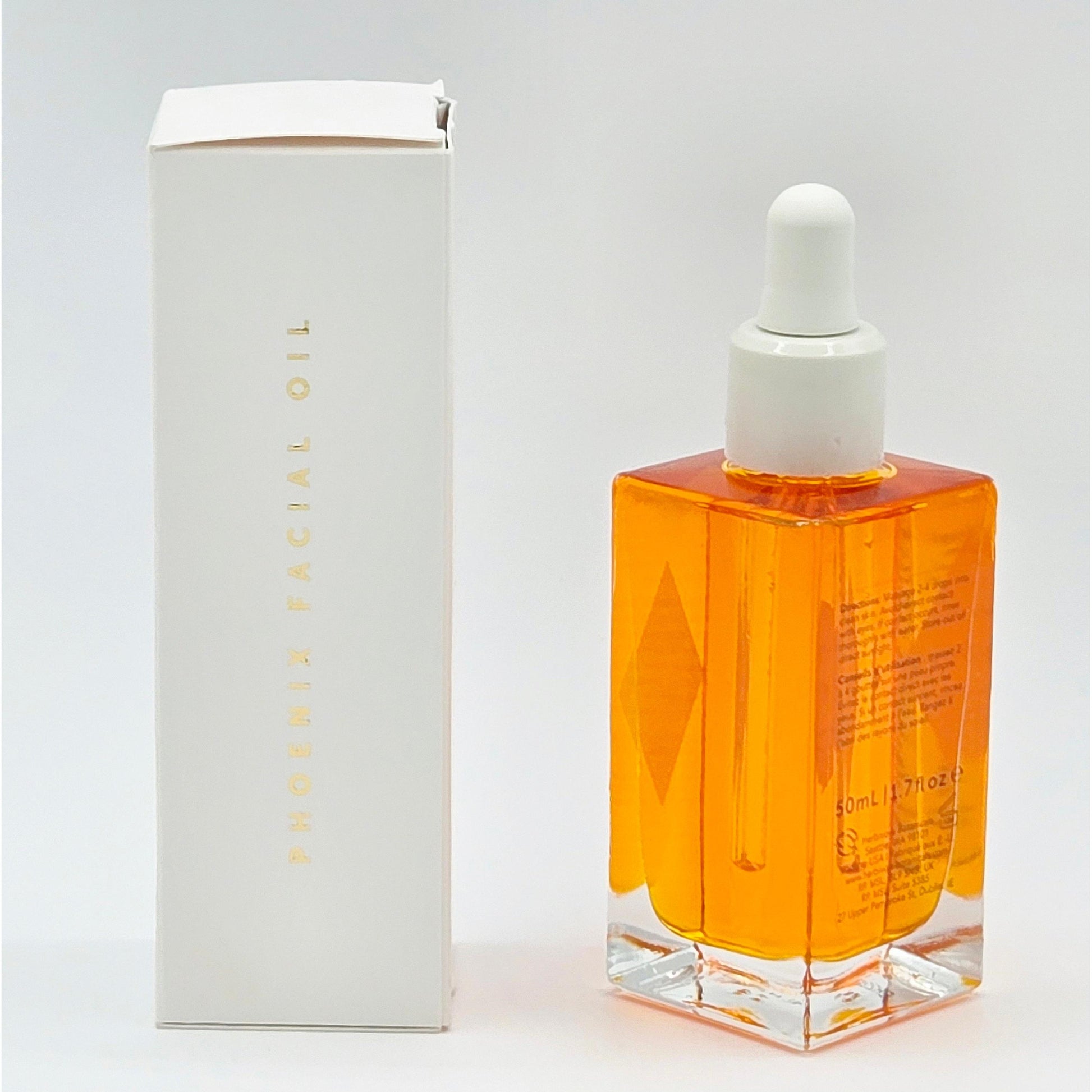 Herbivore Phoenix Deep Renewal Facial Oil 1.7 oz in a clear square bottle with orange liquid, next to a white box.