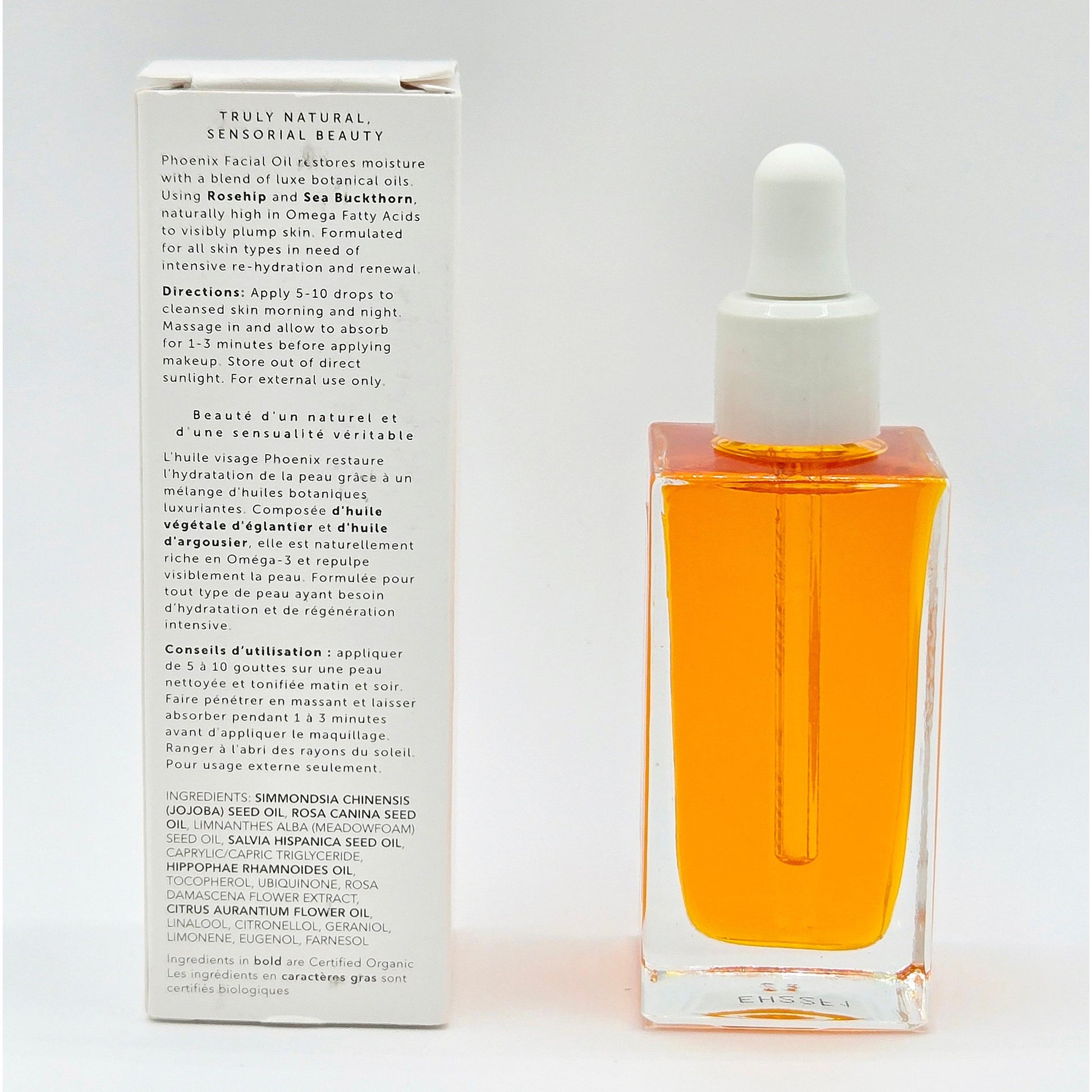 Herbivore Phoenix Facial Oil: 1.7 oz clear glass dropper bottle with vibrant orange oil, next to white box with product details.