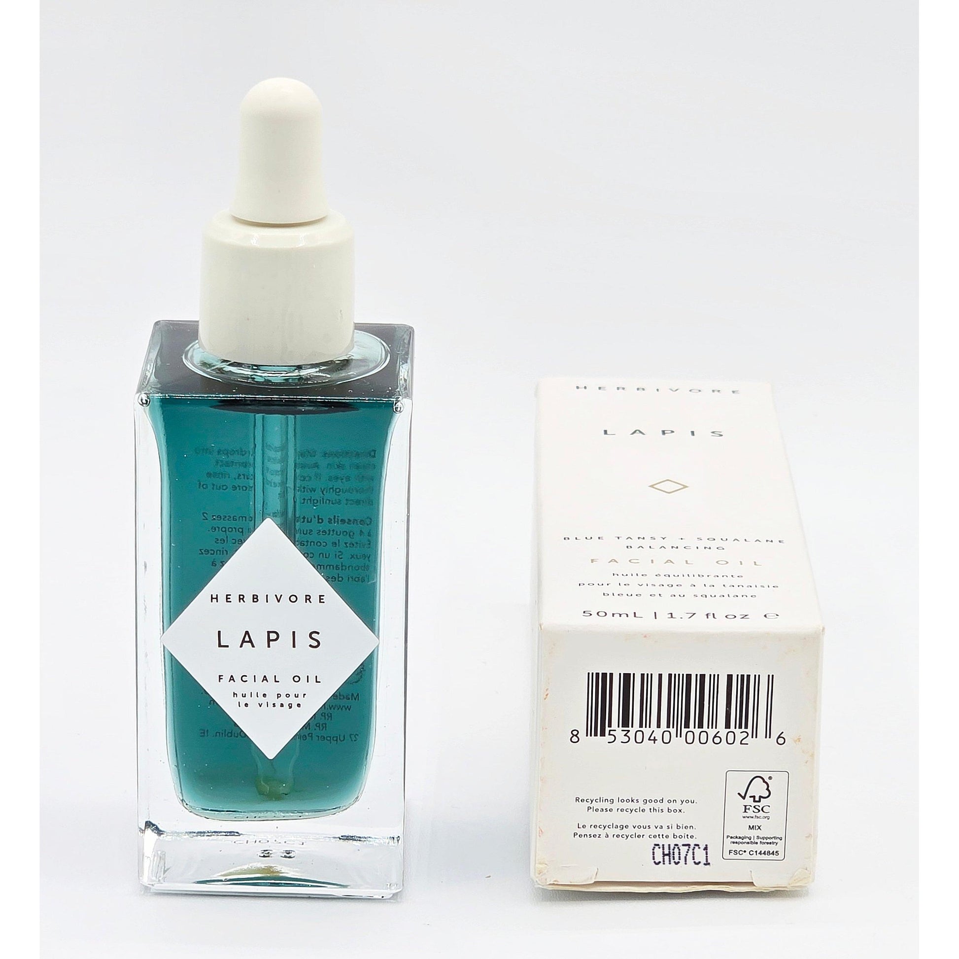 Herbivore Lapis Balancing Facial Oil, 1.7 fl oz, in a square blue glass bottle with dropper, beside its white box.