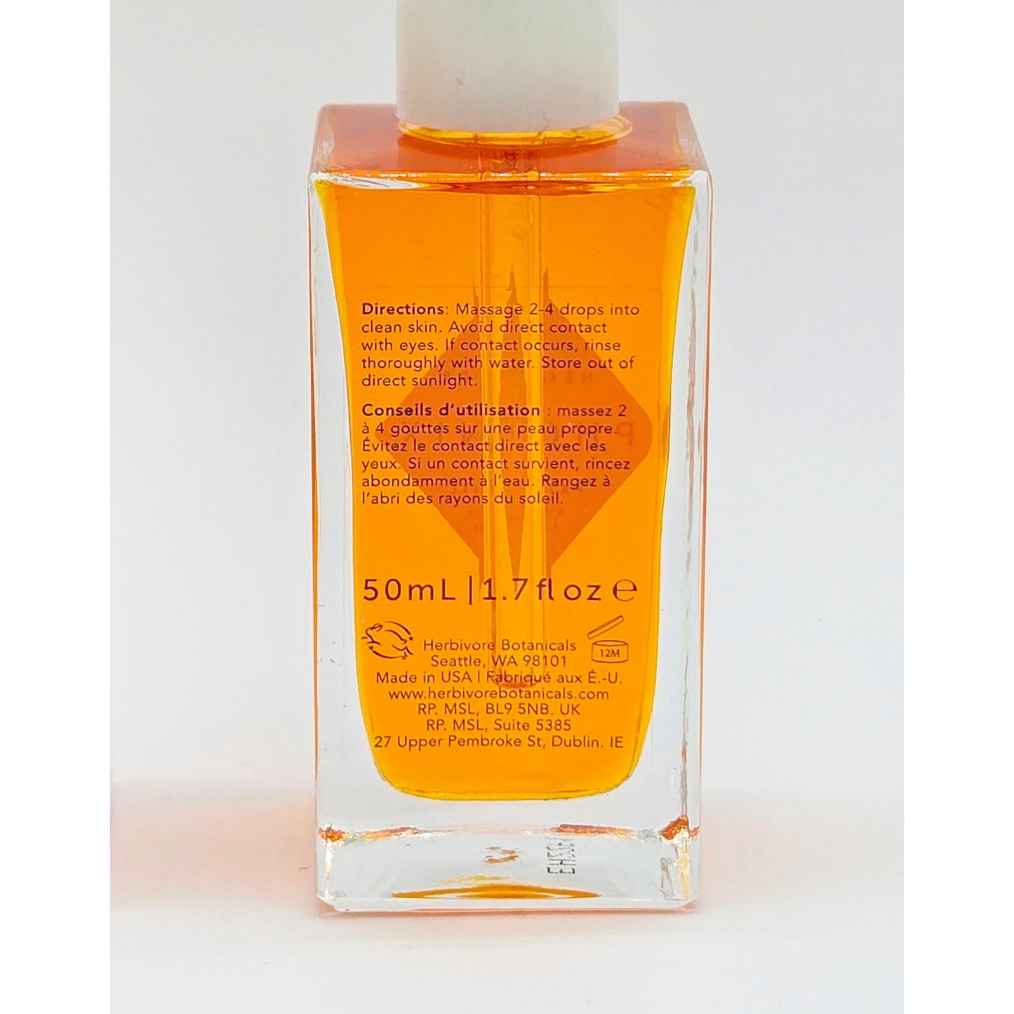 Herbivore Phoenix Facial Oil, 1.7 oz, in a clear glass bottle with orange liquid and white cap.