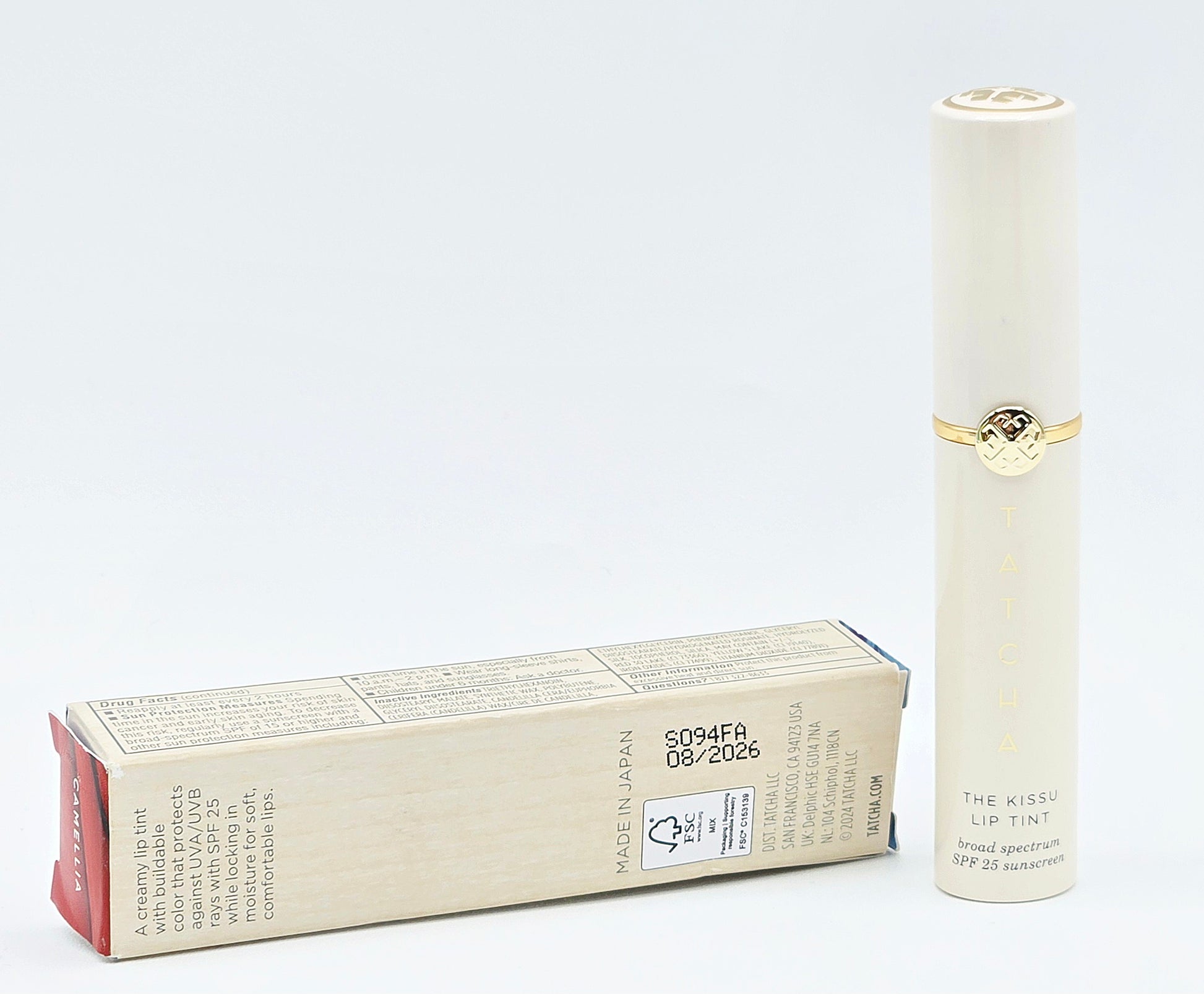 Skincare product and packaging on a light gray background
