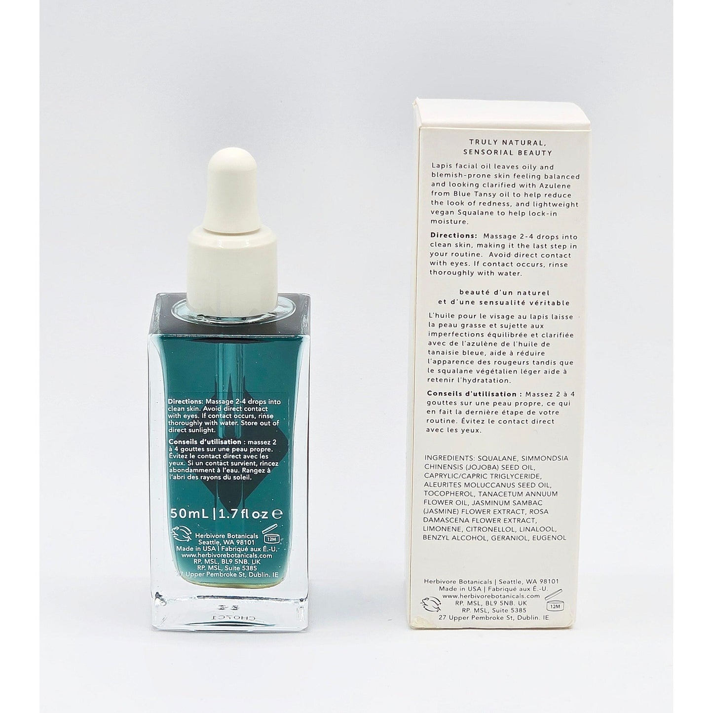 Herbivore Lapis Facial Oil in a clear glass dropper bottle with blue liquid, next to its white product box.