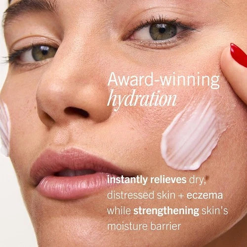 Model with Ultra Repair Cream smoothed onto her cheek, beside hydration and skin-barrier benefit copy.