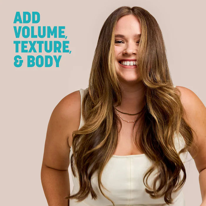 Model with long, voluminous waves beside Drybar Triple Sec text highlighting volume, texture and body