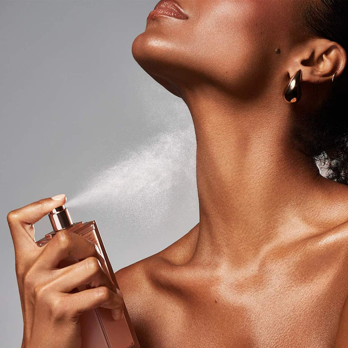 Model spraying PATRICK TA Major Glow fragrance mist toward her neck