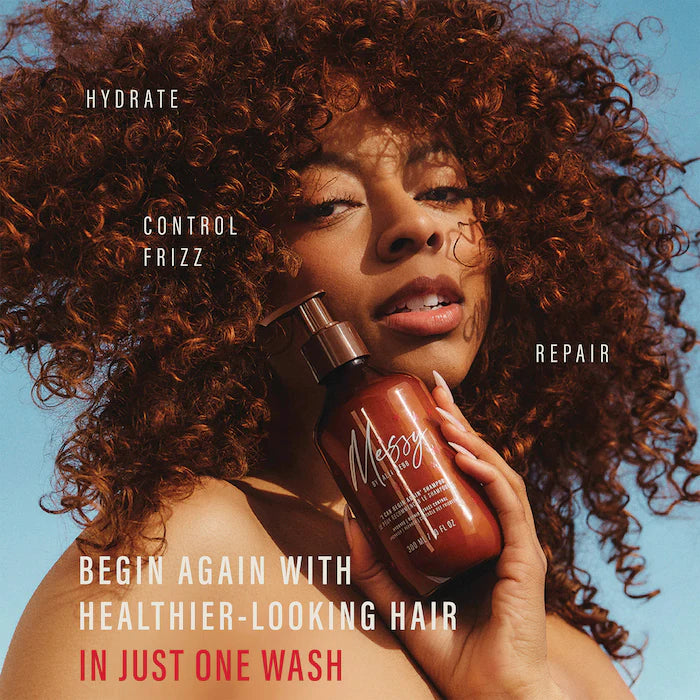 Model with voluminous curls holding Messy shampoo; graphic highlights hydration, frizz control and repair for healthier-looking hair.